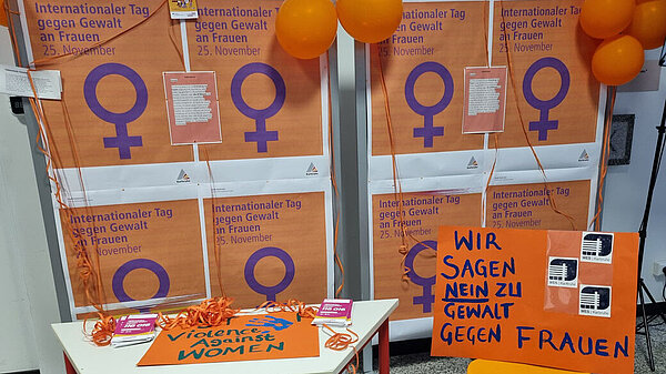 Plakate und Transparente in orange zum Tag gegen Gewalt an Frauen 