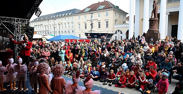 Rathaussturm 2023 Die "Krümel" stehen auf der Bühne auf dem Marktplatz. Vor ihnen sitzt das Publikum,