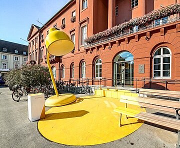 Rathaus mit großer gelber Lampe davor