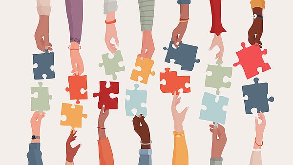 Hände, die sich bunte Puzzle-Teile reichen