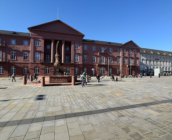 belebter Marktplatz mit Menschen  und Blick auf das Rathaus