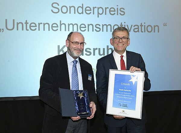 Umweltamtsleiter der Stadt Karlsruhe Norbert Hacker (l.), nimmt den Preis "Leitstern Energieeffizienz 2016" von Helmfried Meinel, Amtschef des Ministeriums für Umwelt, Klima und Energiewirtschaft, entgegen.